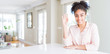 © Krakenimages.com - Wide angle of beautiful african american woman with afro hair Waiving saying hello happy and smiling, friendly welcome gesture