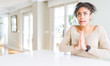 © Krakenimages.com - Beautiful young african american woman with afro hair sitting on table at home begging and praying with hands together with hope expression on face very emotional and worried. Asking for forgiveness.