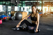 © Love You Stock - Sporty beautiful woman exercising with dumbbell weight training equipment with blurry background, Healthy life and gym exercise equipments and sports concept, with copy space
