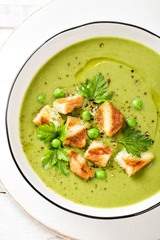 Sticker - Pea soup. Green pea puree soup in a bowl served with grilled toasts, top view