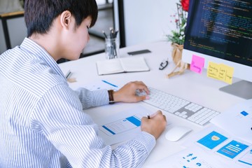 Cropped shot of mobile application designer designing mobile wireframe screens layout for coding or programing mobile application.indoor