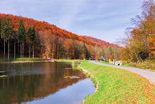 Beautiful Park In The Mountains. Wonderful Sunny Autumn Weather. Walking Path Around The Pond. Trees In Fall Foliage.  Blue Sky With Clouds