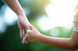 © Khorzhevska - Woman's and kid's hands. Mother lead his child, summer nature outdoor. Parenting, togetherness, help, union, childhood, trust, family concept.