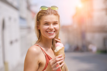 Wall Mural - cheerful girl eating ice cream cone
