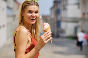 Cheerful girl eating ice cream cone