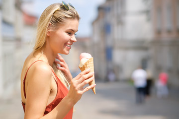 Wall Mural - cheerful girl eating ice cream cone
