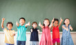 © Tom Wang - Multi-ethnic group of school children standing in classroom