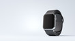 Smart watch with black strap on the white table with copy space at the left side.