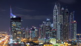 Fototapeta Miasto - Dubai Media City with Modern buildings aerial night timelapse, United Arab Emirates