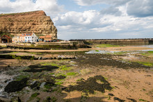 Staithes Is A Seaside Village In The Scarborough Borough Of North Yorkshire, England. Easington And Roxby Becks, Two Brooks That Run Into Staithes Beck