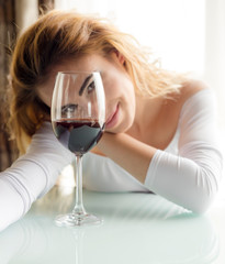 Young beautiful woman with glass of red wine