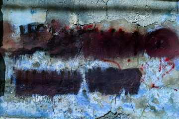 Wall Mural - Old dirty, cracked wall with abstract spray paint texture background. Shaded graffiti tag on an old abstract wall. Stains of dark paint with drips on the surface