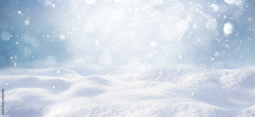 Winter snow background with snowdrifts, with beautiful light and snow flakes on the blue sky, beautiful bokeh circles, banner format, copy space. - obrazy, fototapety, plakaty 