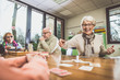 © oneinchpunch - Group of seniors making activities inside the hospice