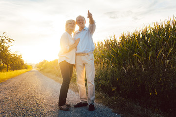 Senior couple enjoying an evening walk in the countryside