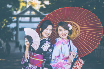 Wall Mural - Two japanese girls wearing kimonos traditional clothes, lifestyle moments