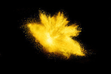 Wall Mural - Yellow powder explosion on black background.