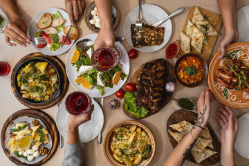 wide and tasty table covered with delicious ukrainian cuisine on which sits a large family or friend