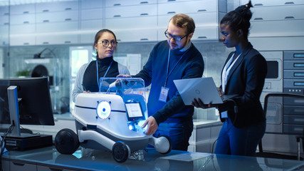 Wall Mural - multi ethnic team of male and female leading scientists work on innovative robotics technology. they