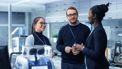 multi ethnic team of male and female leading scientists discussing innovative robotics technology. t