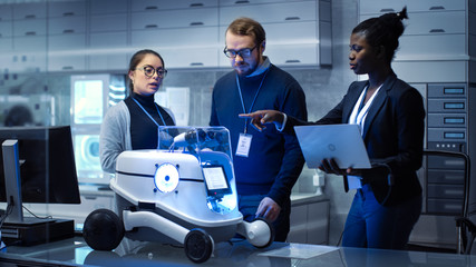 Wall Mural - multi ethnic team of male and female leading scientists work on innovative robotics technology. they
