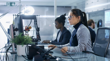 Wall Mural - white female working on a computer with her colleagus in a modern high-tech laboratory.