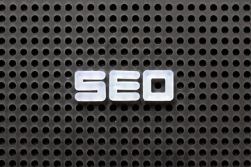 Wall Mural - Black color pegboard with white letter in word SEO (Abbreviation of search engine optimization)