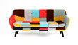 Modern scandinavian bright sofa of colorful cloth scraps, patchwork. Sofa with wooden black legs on isolated white background. Furniture, interior object, stylish sofa