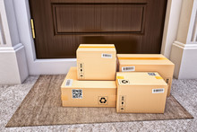 Internet Shopping, Online Purchases, E-commerce And Express Package Door-to-door Delivery Service Concept, Cardboard Boxes On The Door Mat Near The Entrance Door