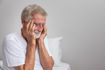 Wall Mural - Senior elderly man sitting on bed with depressed after waking up in morning