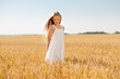 © Syda Productions - nature, harvest and people concept - smiling young girl on cereal field in summer