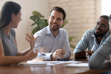 Poster - Happy business woman telling joke to male colleagues at meeting