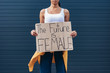 cropped view of feminist holding placard with inscription the future is female
