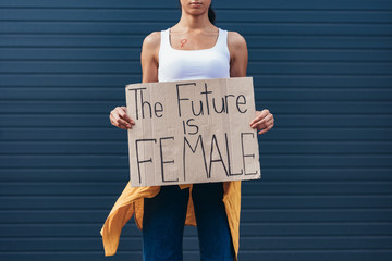 cropped view of feminist holding placard with inscription the future is female