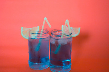 Two refreshing cocktails with lemon and straw