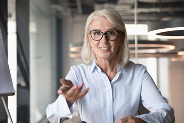 mature businesswoman looking at camera and talking, making video call