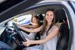 © RomanR - Two happy girls smiling and travelling in car