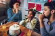 © Mediteraneo - Happy family celebrating a birthday together at home