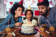 © Mediteraneo - Happy family celebrating a birthday together at home
