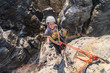 Girl rock climber abseiling from sandstone towers, Tisa sandstone rocks, Usti nad Labem region, Czech republic