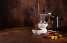 Coffee Pot With Spices On Brown Background.