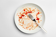 Dirty Plate With Food Leftovers And Fork On White Background, Top View