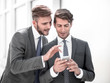 © ASDF - young employees discussing media files on a smartphone