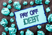 Conceptual Hand Writing Text Showing Pay Off Debt. Concept Meaning Reminder To Paying Owed Financial Credit Loan Bills Written Sticky Note Paper Folded Paper The Wooden Background.