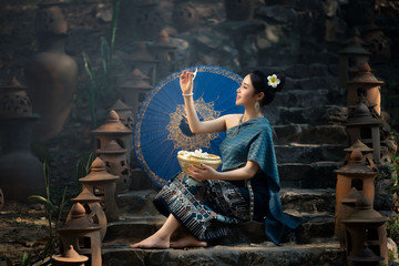 Beautiful asian woman in traditional costume at temple, Laos woman