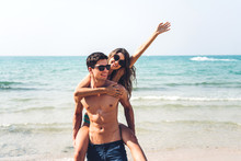 Romantic Lovers Young Couple Relaxing Together On The Tropical Beach.Man Hugging With Woman And Enjoy Life.Summer Vacations