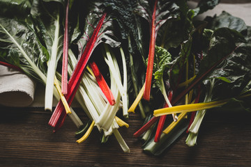 Fresh chard leaves on wooden boards