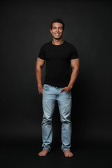 handsome young african-american man on black background