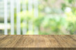 © sorrapongs - Empty wood table top on blurred background at garden in shopping mall, copy space for montage you product.