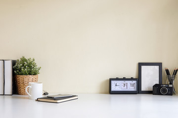 Mockup workspace desk and copy space books,plant and coffee on white desk.